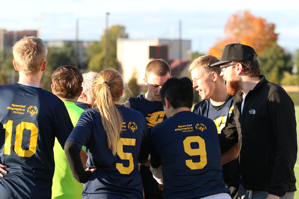 SO College participants huddle during a Unified soccer game.