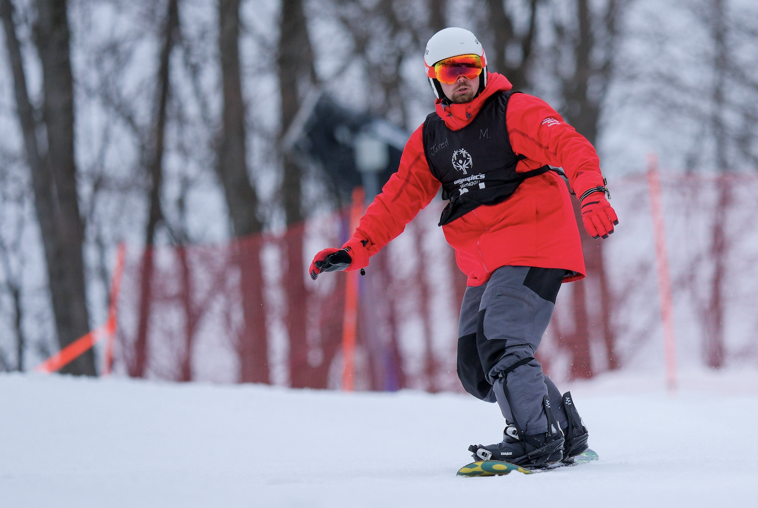 athlete snowboarding down hill