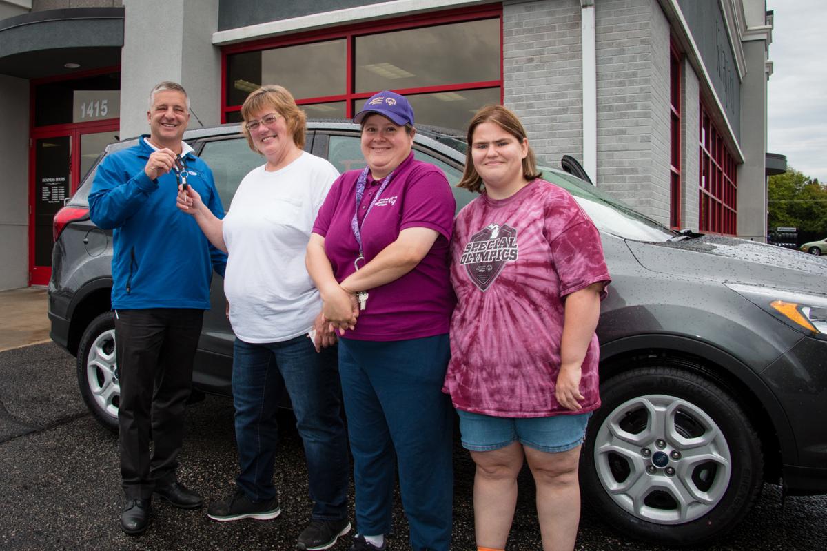 Raffle winner Teresa Carlson receives the keys to her brand new Ford Escape.