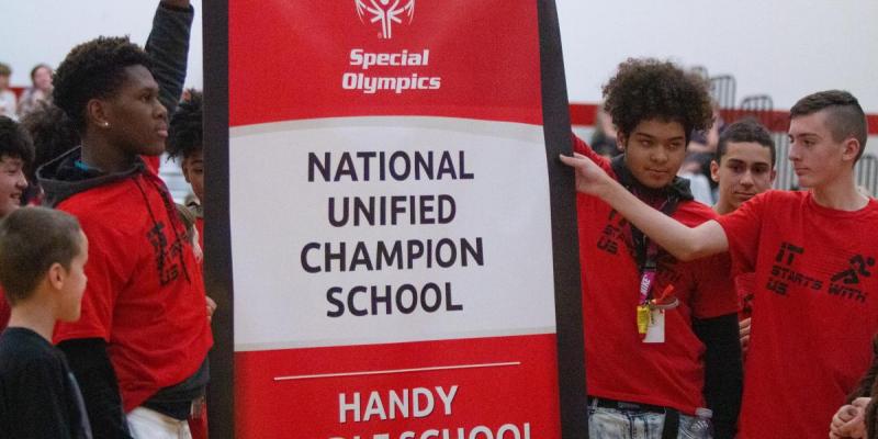 Students at Handy Middle School raise the school's National Banner